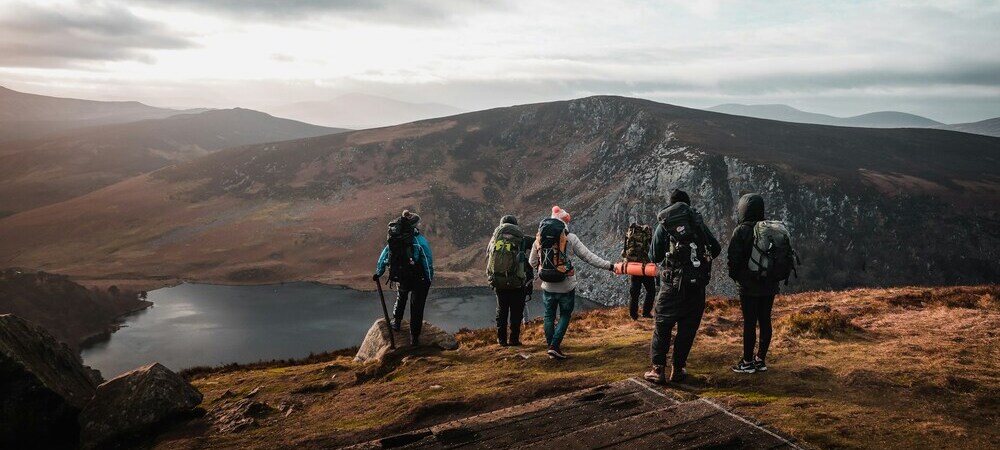 Hikers near Lough Tay in the Wicklow Mountains by Gregory DALLEAU