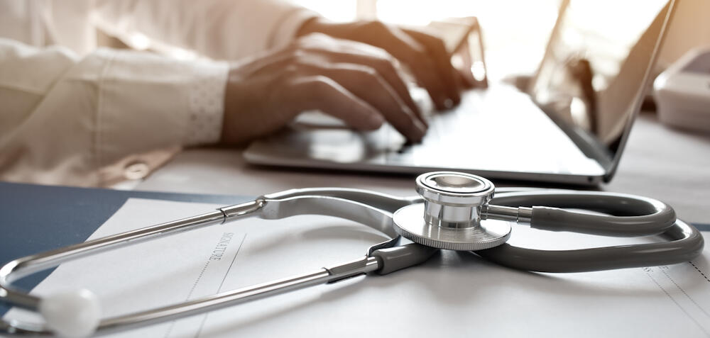 Stethoscope next to laptop