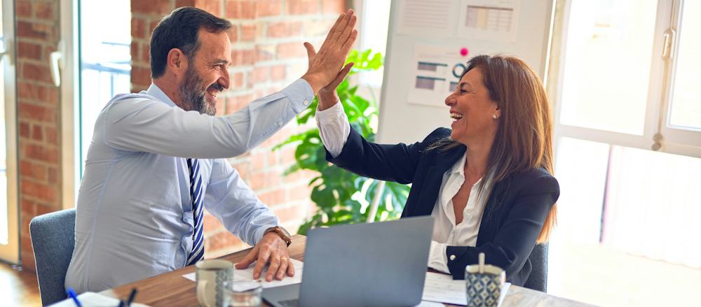 Businesspeople High-fiving by KrakenImages on Unsplash